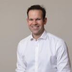 Matt Canavan seated in a white shirt against a grey background