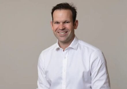 Matt Canavan seated in a white shirt against a grey background